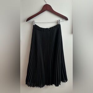 Just below the knee Pleated skirt